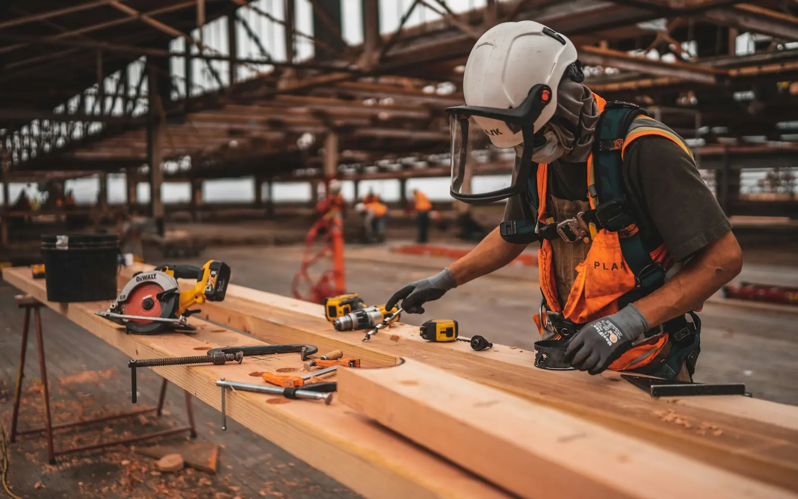 Carpenter cutting lumber on a steel-frame jobsite