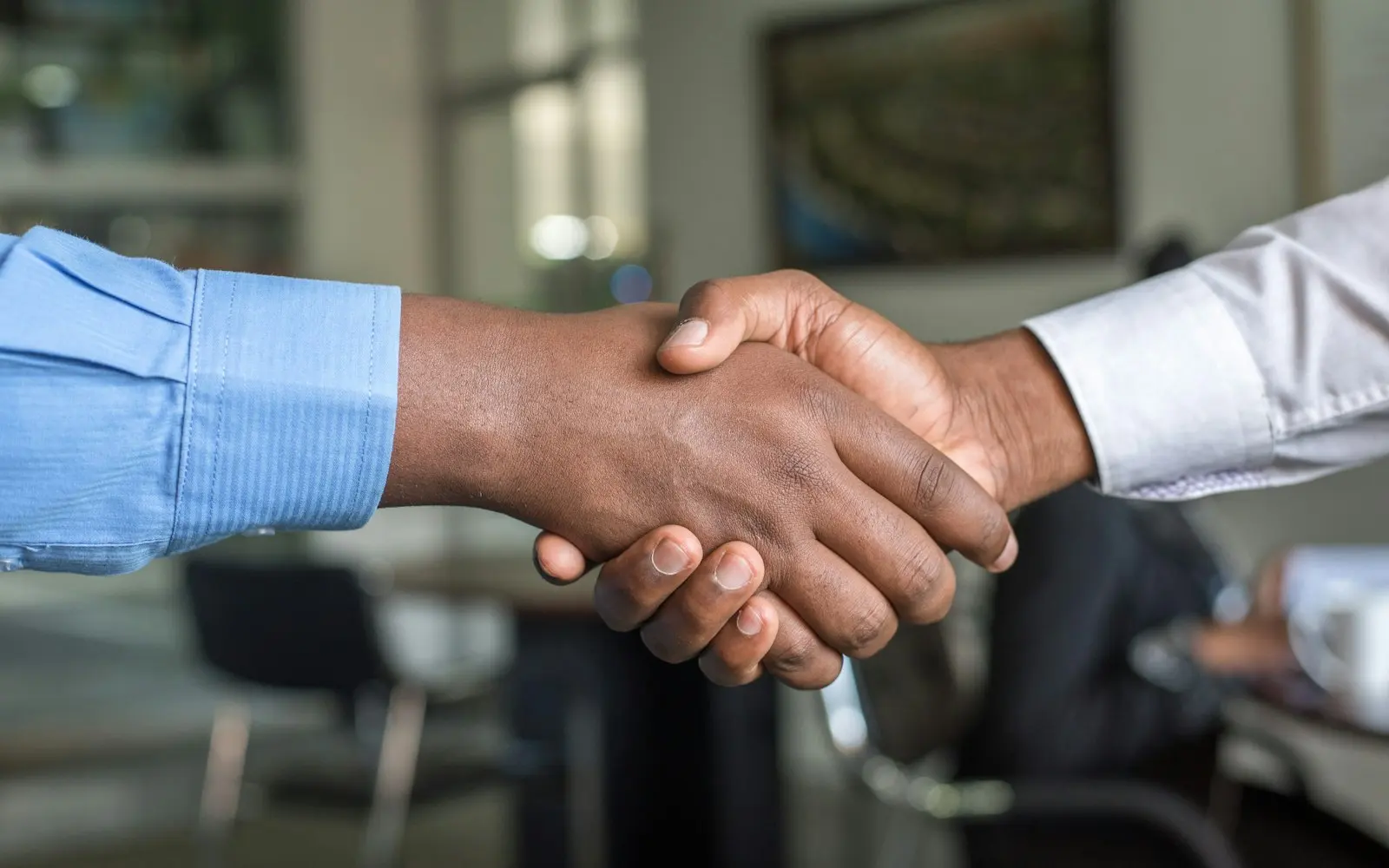 Handshake across a desk after a recruiting conversation