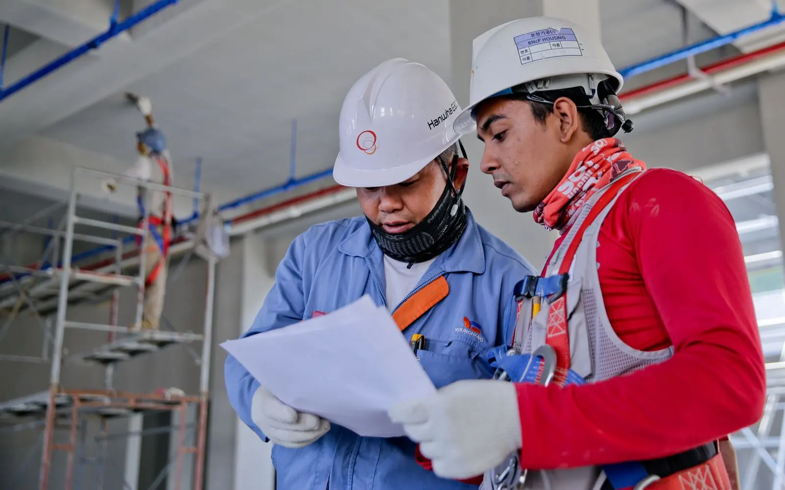 Two construction professionals reviewing a document on site