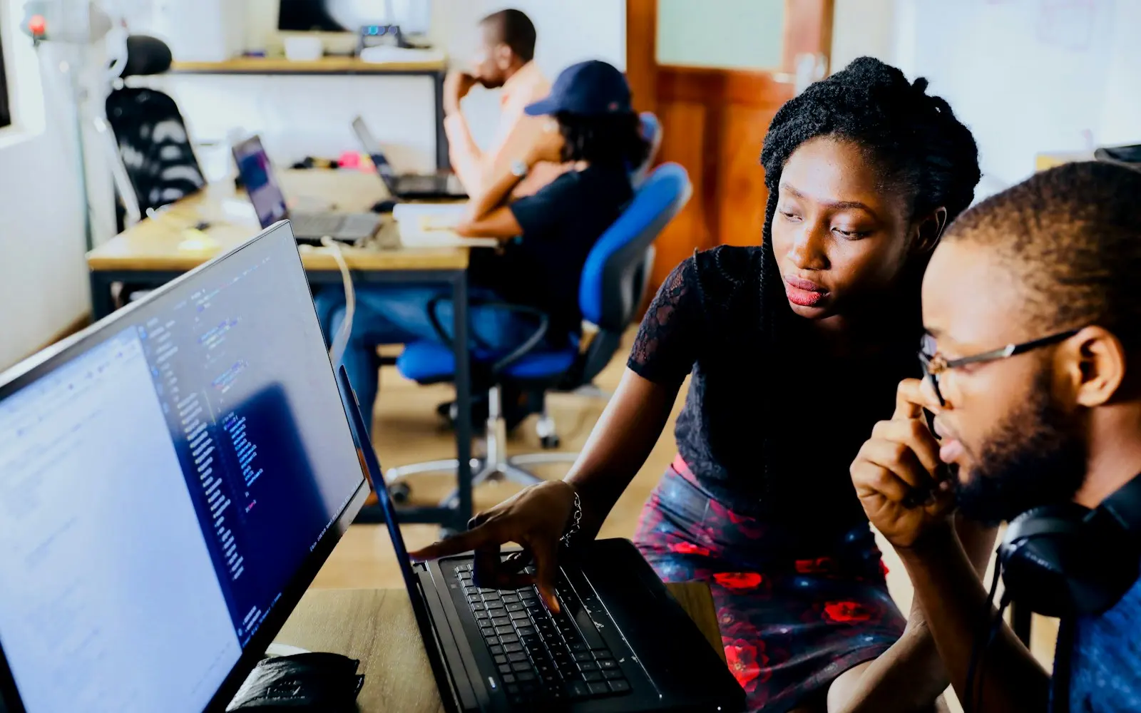 Engineers reviewing work together on a screen
