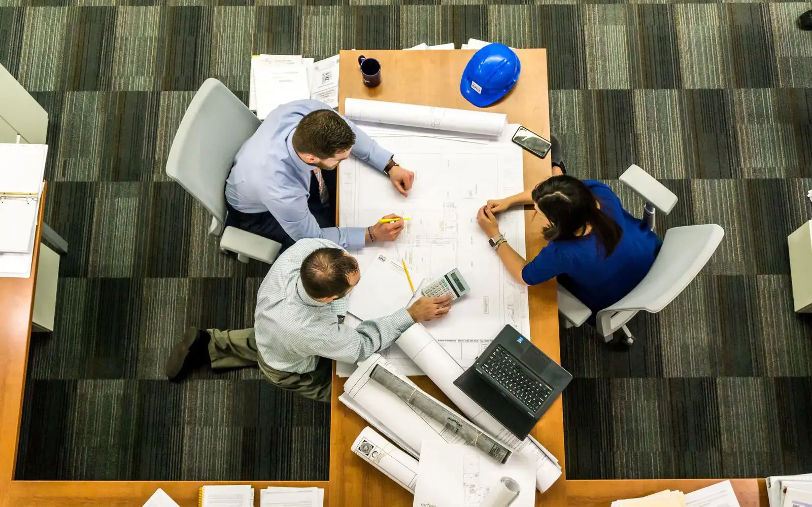 Project team reviewing drawings around a table