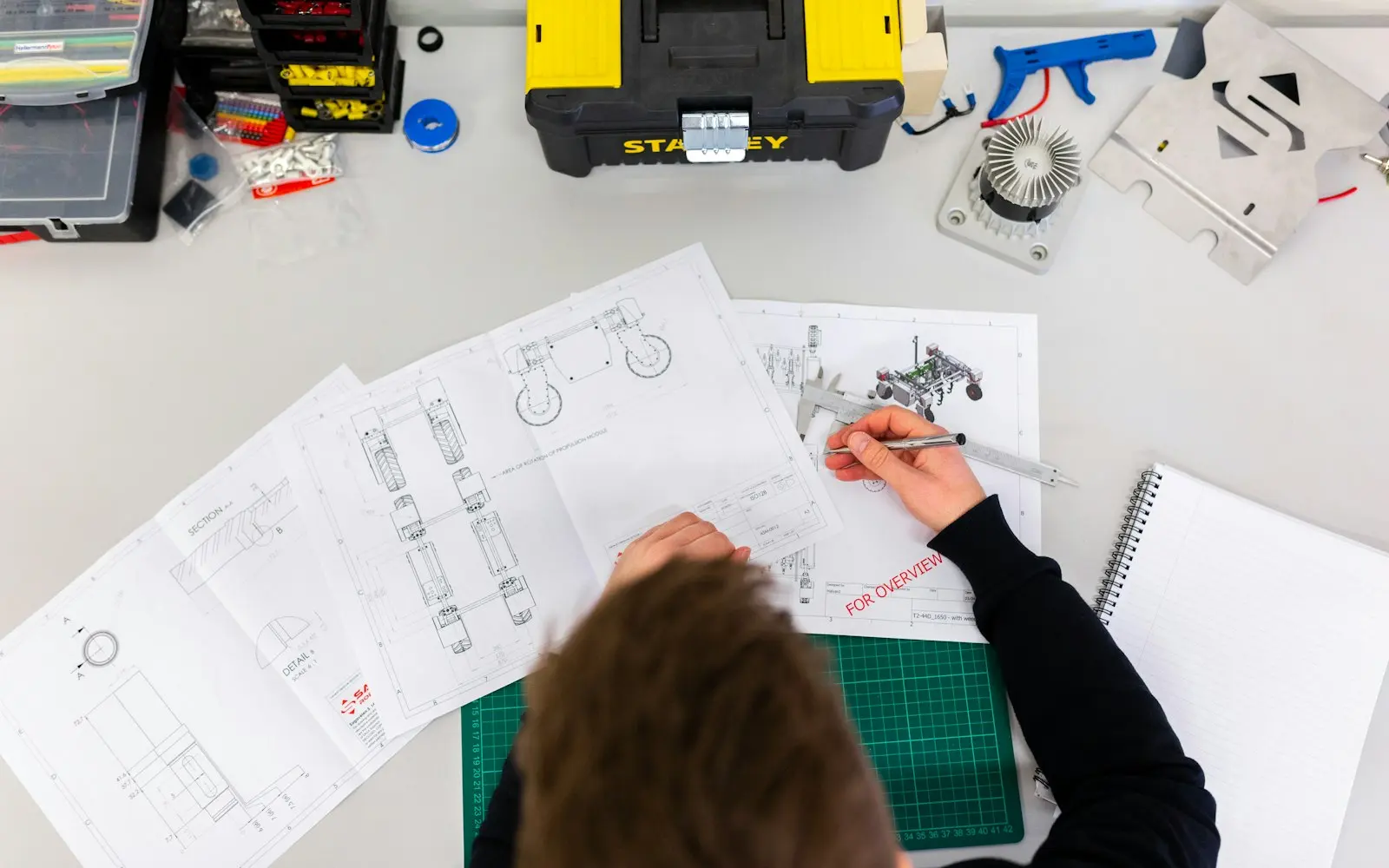 Engineer marking up mechanical drawings