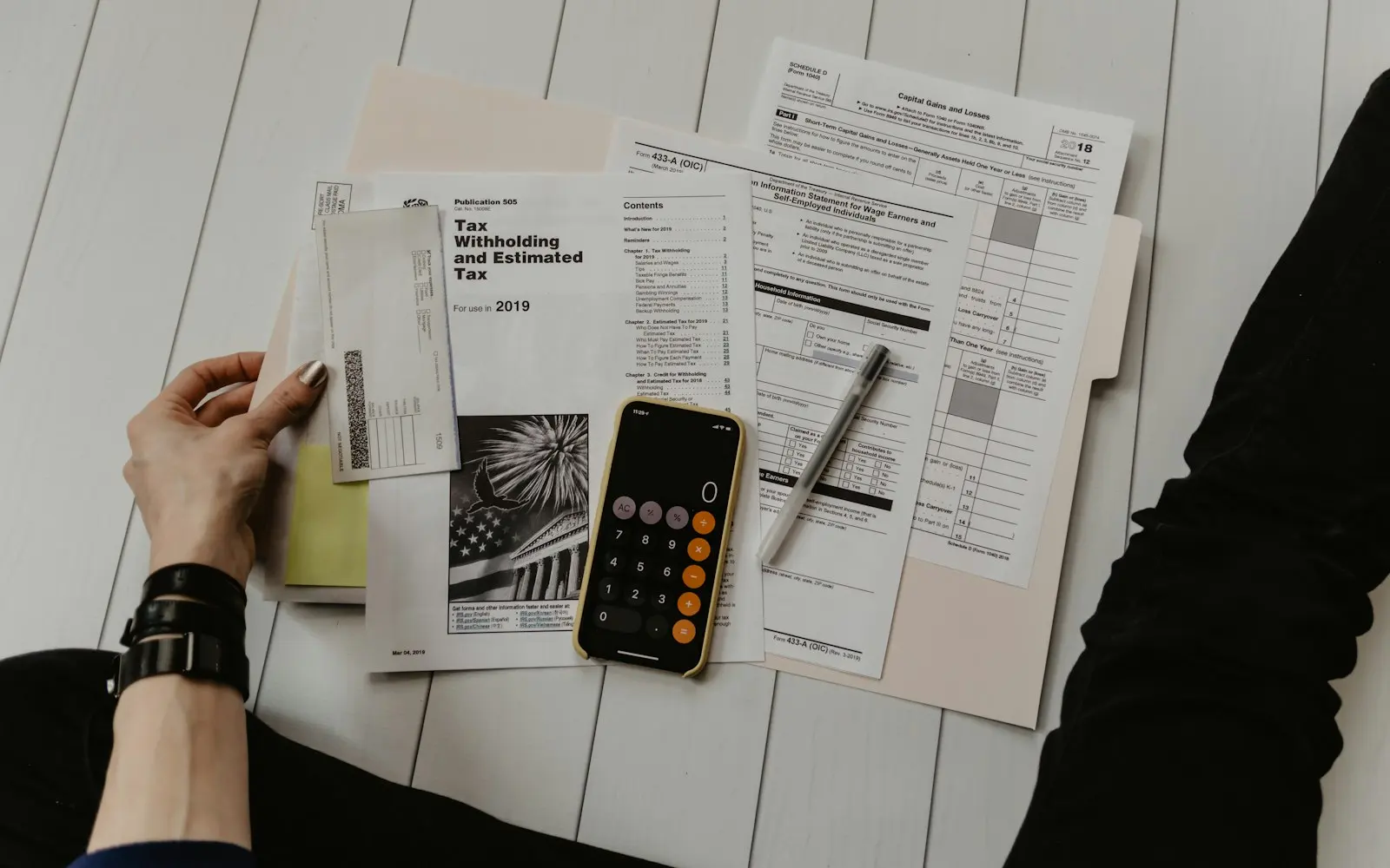 Accounting work with tax forms and a calculator on a desk