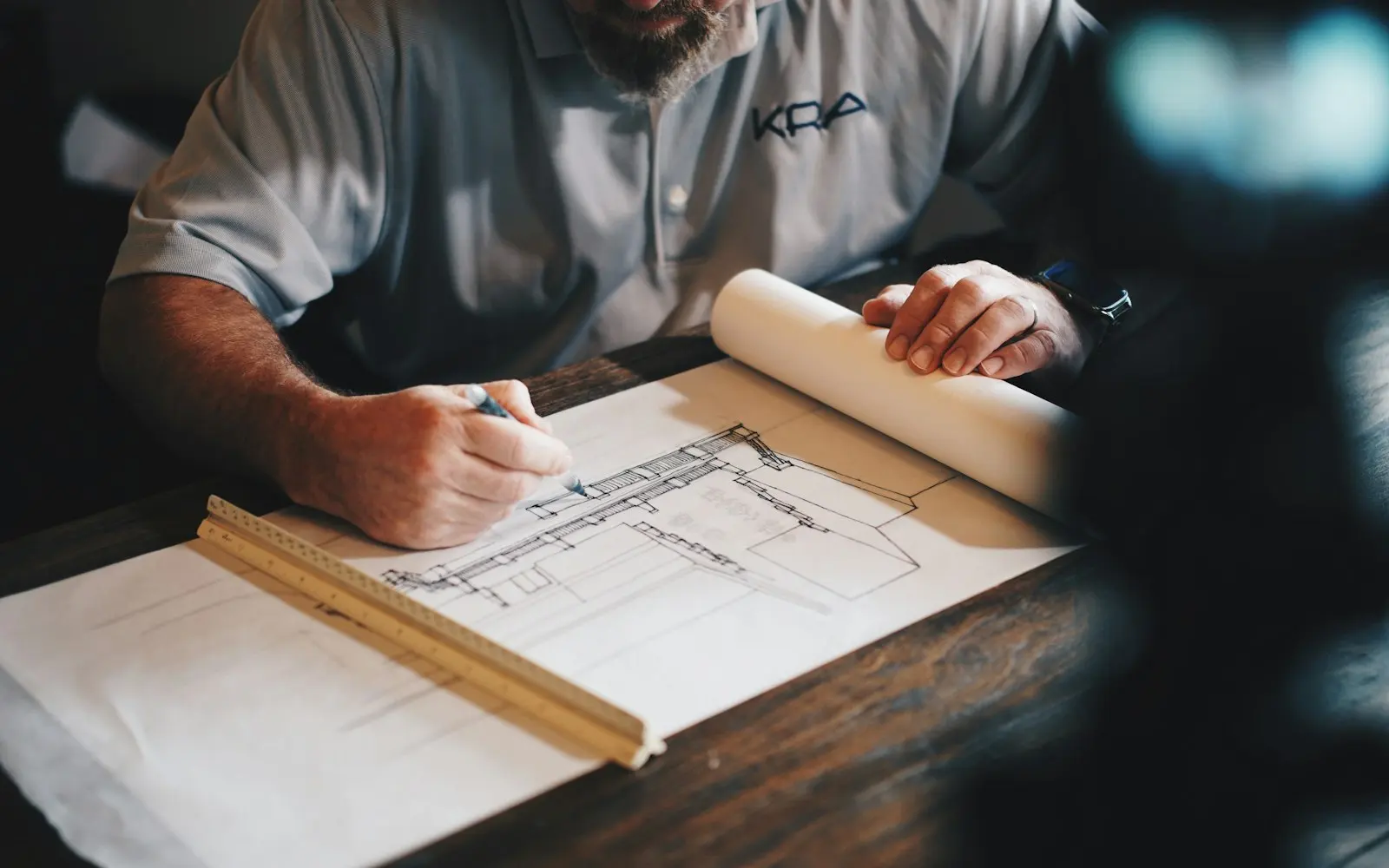 Architect drawing a building plan at a desk